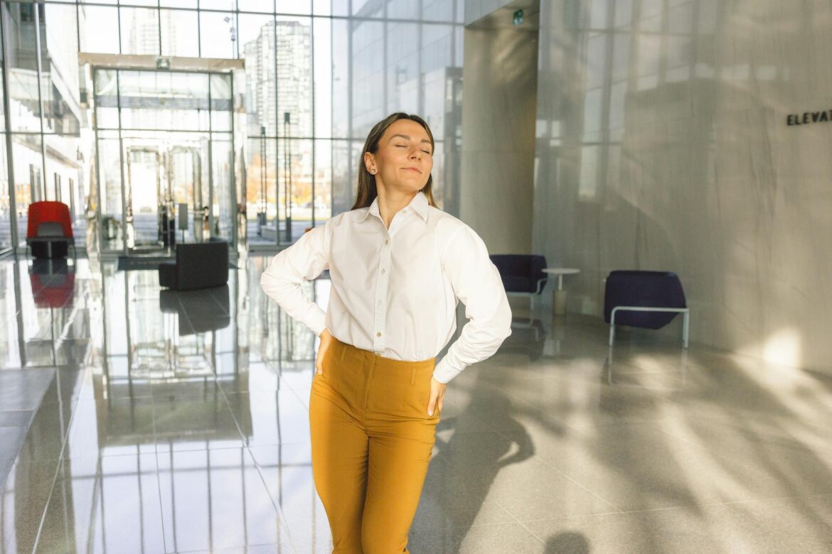 woman wearing white long sleeves and brown pants